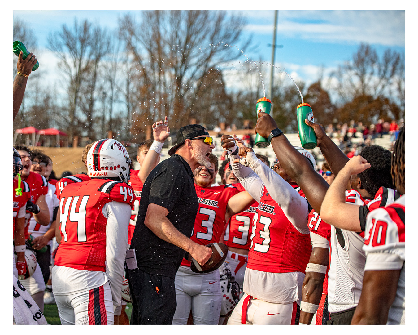 Nate Garner celebrating with players after a win