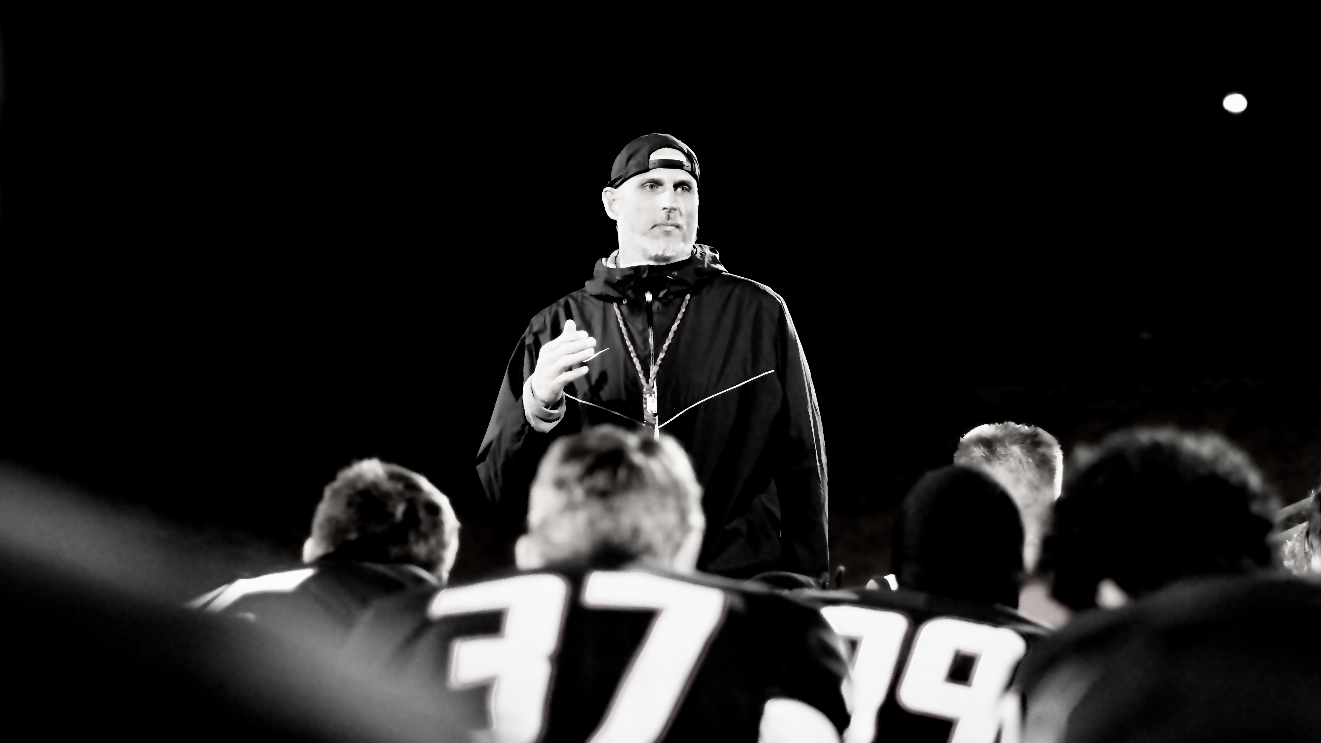 Nate Garner speaking to his team under the lights